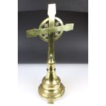 Brass Celtic cross with fleur-de-lys design, with flared bell-shaped base on three feet, engraved to