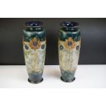 Pair of Royal Doulton Art Nouveau vases of tapering form, relief decorated with stylised flowers,