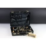 A Selmer Company Bundy cased clarinet together with a Hohner harmonica.