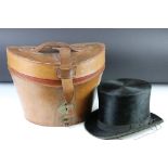 Black moleskin top hat, in leather case with burgundy lining