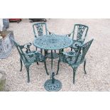 Green painted metal patio set to include four chairs, a table and an umbrella stand