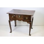 George III Elm Lowboy or Side Table with an arrangement of three drawers and shaped apron, raised on