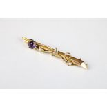 An early 20th century fully hallmarked 9ct gold bar brooch with seed pearl and amethyst.