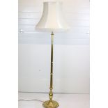 20th century Brass Corinthian Column Standard Lamp raised on a circular base with four feet, with