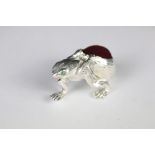 A silver plated frog style pincushion.