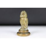 A cast metal table top inkwell in the form of an owl with glass eyes and flip top lid.