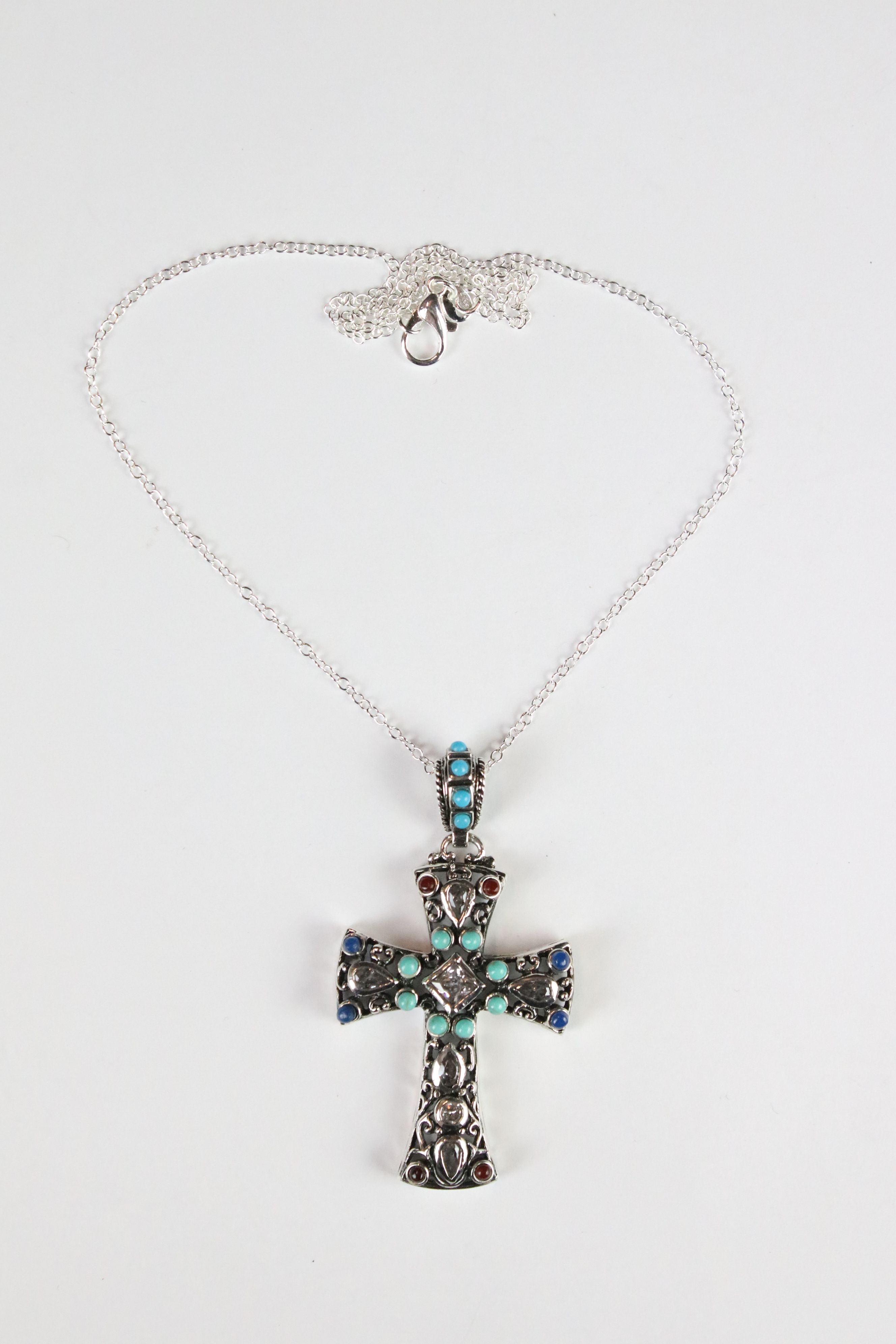 A silver pendant cross set with turquoise and ruby cabochons. - Image 2 of 4