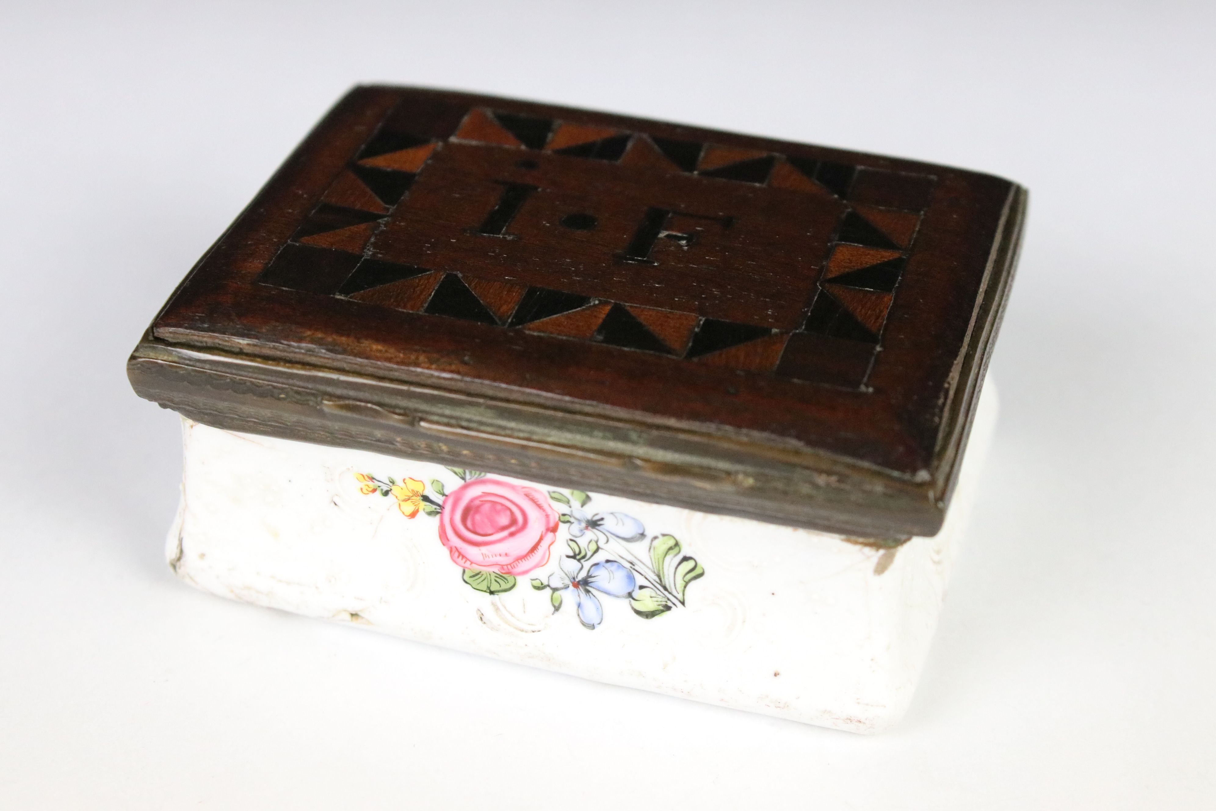 An antique enamel trinket box with floral decoration an decoratively inlaid wooden lid, initialed