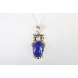 A large silver and lapis lazuli owl pendant necklace.