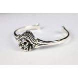 A silver skeleton style bangle.