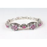 A substantial silver marcasite and ruby line bracelet.