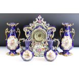 Early 20th century pottery clock garniture set in majolica style: comprising: clock printed with