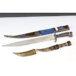 Two Arabic daggers both complete with sheaths.