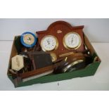 Collection of clocks and barometers including cuckoo clocks.