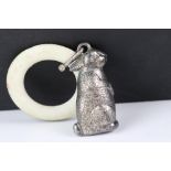 White metal babies rattle and teething ring in the form of a rabbit.