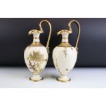 Pair of late 19th Century Wedgwood jug vases. Each decorated with gilt floral sprays with an