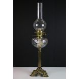 19th Century Victorian brass and glass oil lamp having a clear glass reservoir raised on a brass