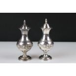 Pair of silver pepperettes.