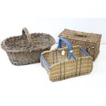 Three wicker baskets to include a lidded picnic / fishing basket and an oval example with loop