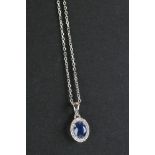 An 18ct white gold sapphire and diamond pendant necklace of 73 points total