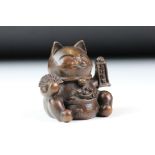 An ornamental Japanese bronze 招き猫 / maneki-neko (waving / beckoning) lucky cat talisman.