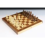 Jaques London folding wooden chess board having a full set of matching turned wooden chess pieces.