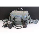 A Olympus OM10 35mm SLR film camera complete with lenses and accessories.