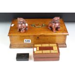 A small group of collectables contained within a vintage wooden box to include a cribbage board