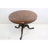 George III Oak Circular Tilt Top Low Table raised on three splayed legs, 84cm diameter x 55cm high