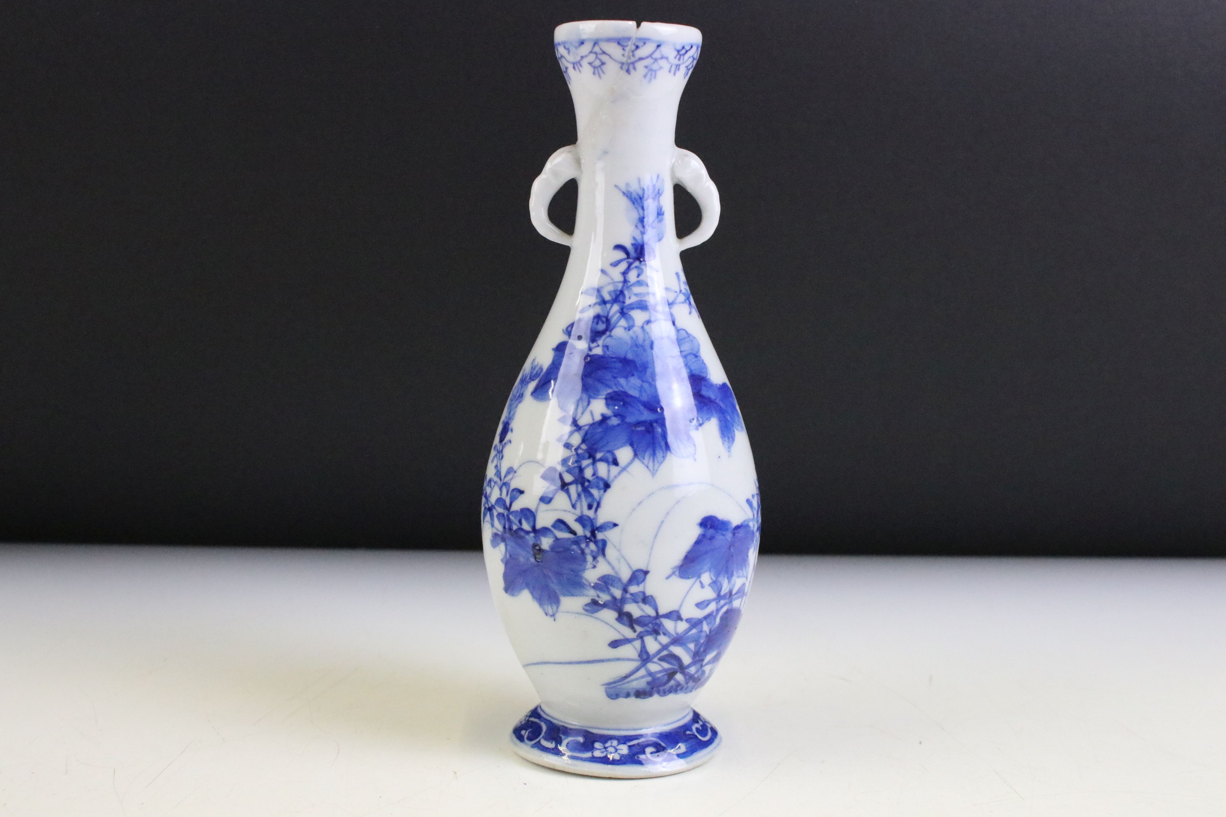 Chinese blue and white vase of baluster form with twin handles being hand painted with floral sprays