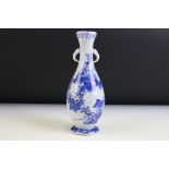 Chinese blue and white vase of baluster form with twin handles being hand painted with floral sprays