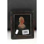 Moulded cameo portrait featuring a classical female set to an ebonised wooden board in an ebonised