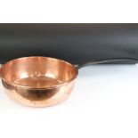 Large 19th Century copper sauce pan having a cast iron handle. Measures 37cm diameter.