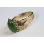A vintage 9ct gold ring set with Jade cabochon centre stone.