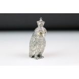 A large owl wearing a crown perfume bottle.