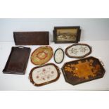 Collection of seven wooden twin-handled serving trays to include a WW1 era tray with carved floral