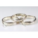 A collection of three fully hallmarked sterling silver cuff bangles with engraved decoration.