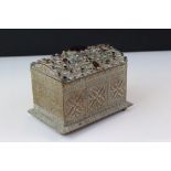 An ornate decorative asian musical trinket box decorated with semi precious stones and seen pearls.