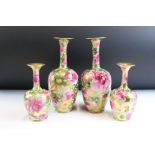 Pair of Victorian vases of bottleneck form, decorated with pink roses and foliage against a gilt