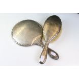A fully hallmarked sterling silver hand brush and mirror set, assay marked for Birmingham.