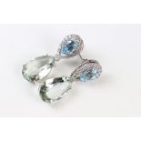 A pair of silver CZ and aquamarine pear shaped drop earrings.