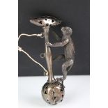 A hallmarked sterling silver babies rattle in the form of a climbing monkey (A/F).