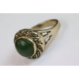 A vintage 9ct gold ring set with Jade cabochon centre stone surrounded with marcasite.