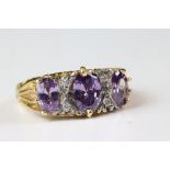 A gold plate on silver ring set with amethyst and diamonds.