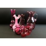 Collection of cranberry glass to include: a vase of twisted form with single clear glass handle,