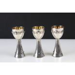 A trio of W.M.F. arts and crafts silver plated toasting goblets with gilt bowls by Albin Muller.