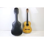Six string acoustic guitar, with spare strings and case (guitar approx 100cm long)