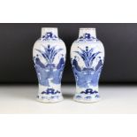 Pair of Chinese blue and white vases of baluster form, each painted with a pair of seated figures