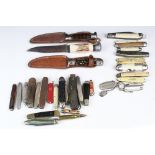 A collection of mixed penknives together with three vintage scouting / sheath knives.