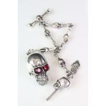 A large silver albert style watch chain of skull form.